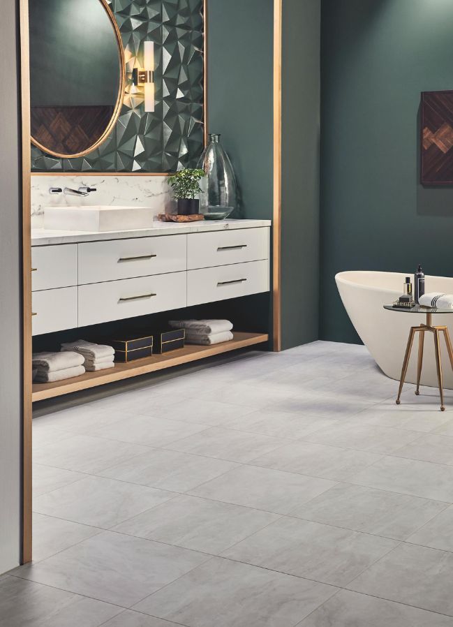 luxury vinyl tile flooring in an elegant bathroom with green accent wall