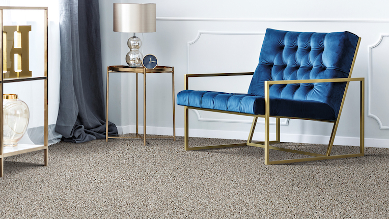 textured grey carpets in a living room with blue accent chair